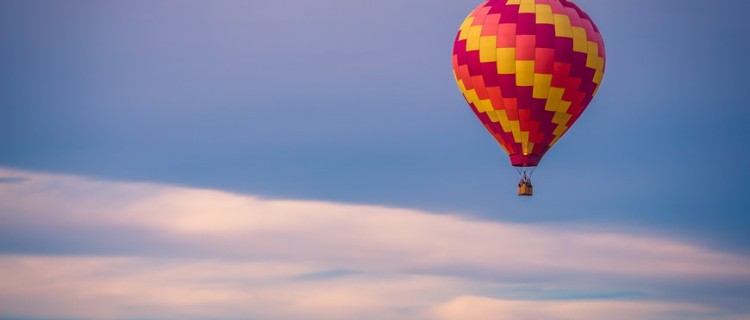 red and yellow hot air balloon in the sky