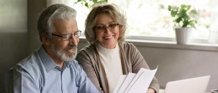 Elderly couple reading mail