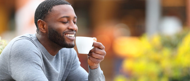 relaxed man drinking a cup of coffee