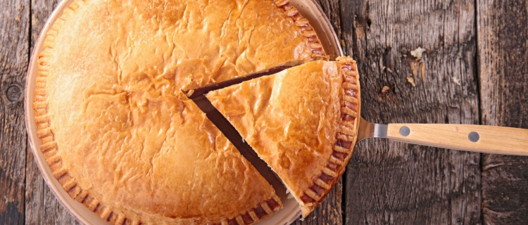 A large pie with a slice cut out.