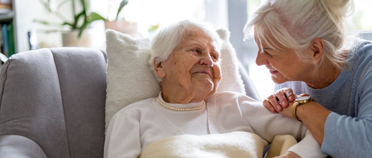 A carer sitting with a resident.