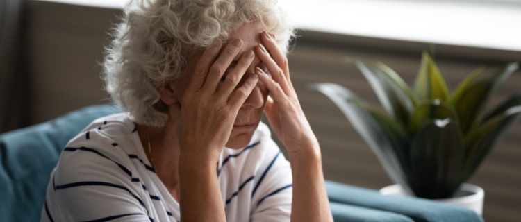 An old woman with her head in her hands