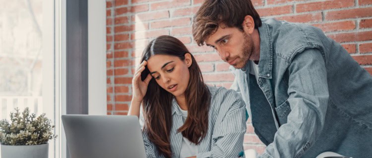 A young couple looking at a computer.