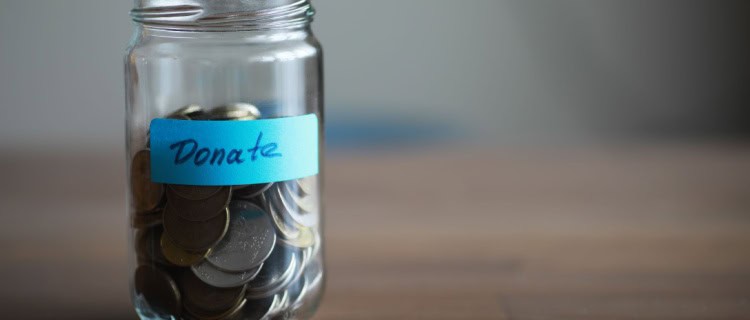 A donation jar filled with coins.