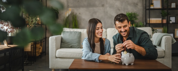 A couple saving in a piggy bank.
