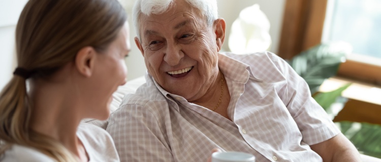 A younger lady and an older man having a conversation.