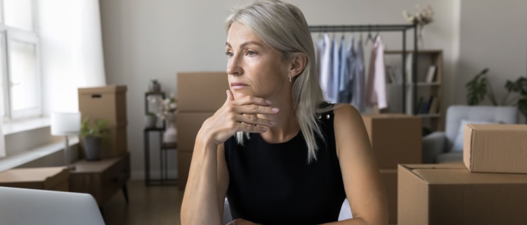 A woman at her desk, deep in thought.