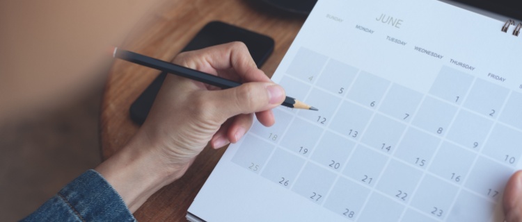 A woman marking days on a calendar