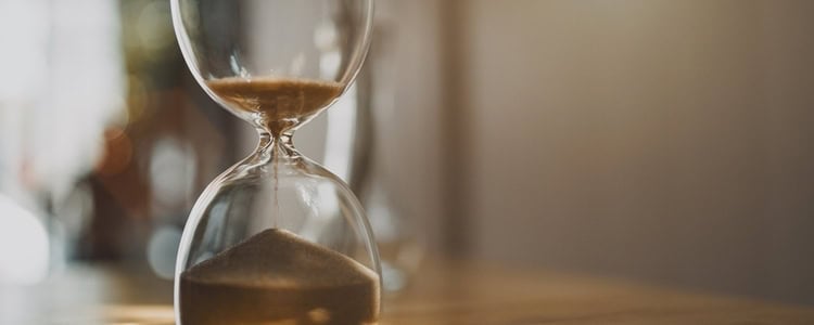 Hourglass with sand running out inside